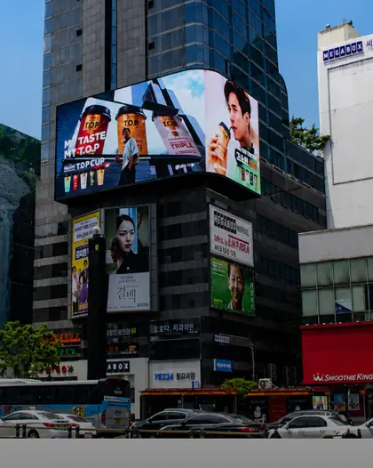 Digital billboards on high-rise façades at a busy intersection in Seoul, South Korea